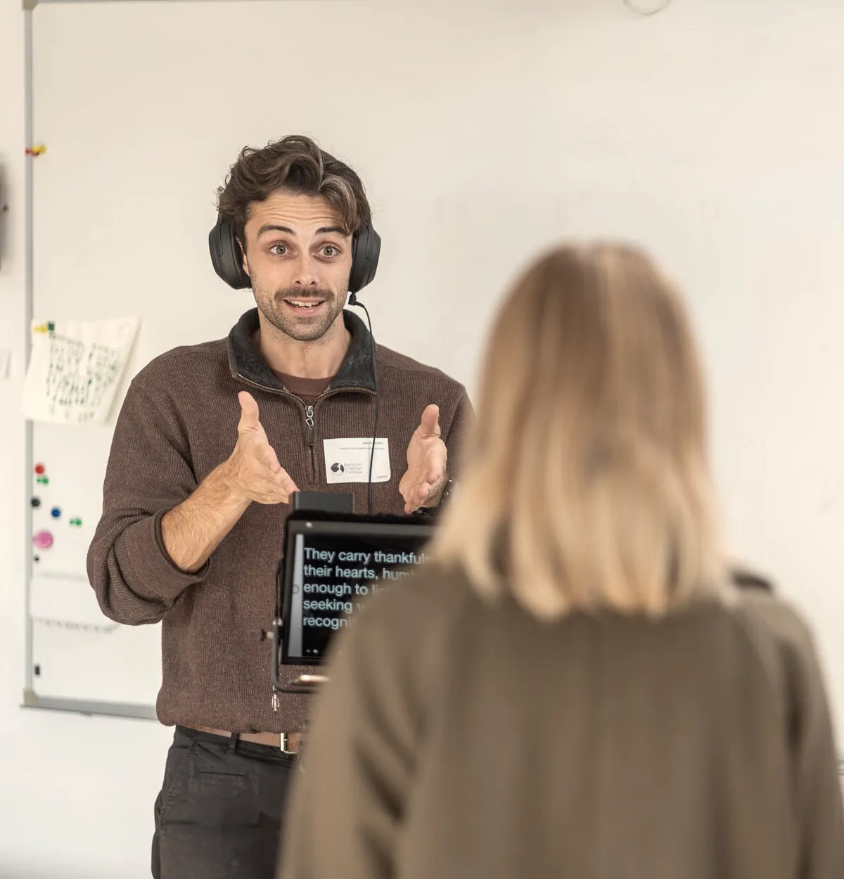 Jacob in headphones, explaining a shot on a school film shoot