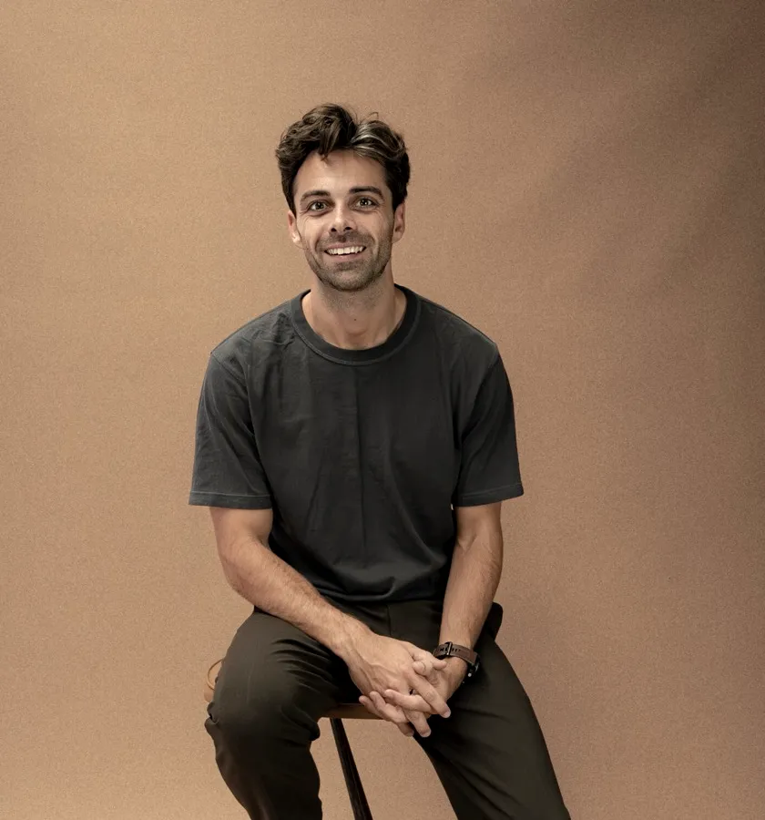 Jacob seated on a stool against a brown backdrop